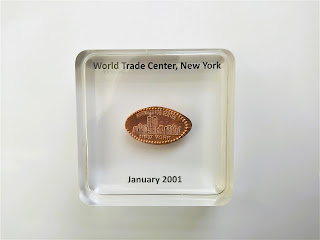 Bespoke resin paperweight containing a souvenir coin