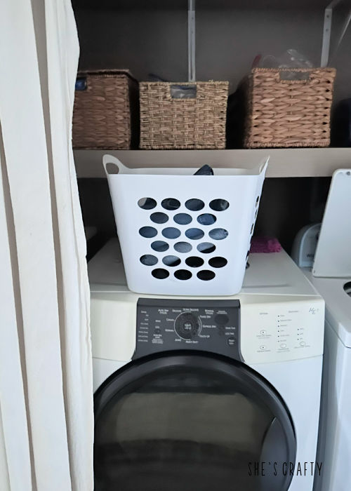 Laundry Closet with baskets on shelves.