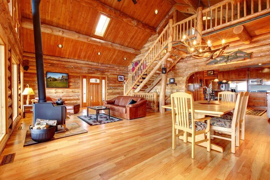 Open-concept cabin interior seamlessly connecting kitchen, dining, and living areas
