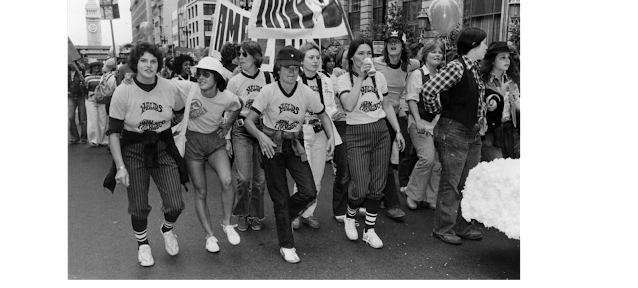 Group of women marching wearing t-shirts reading "Maud's" SF gay pride parade 1977