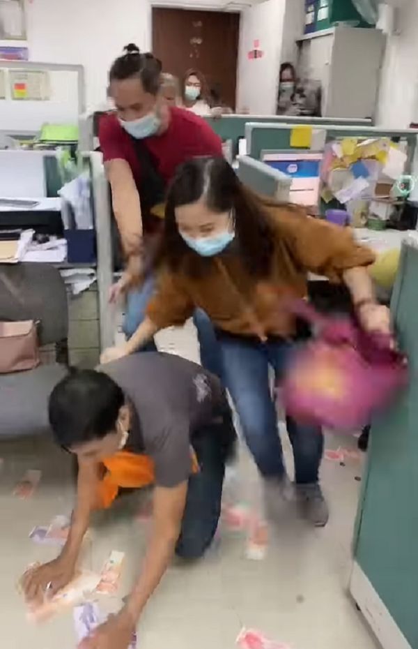 Workers scramble to pick money from floor in office game
