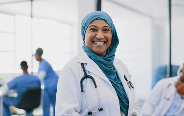 Female doctor smiling wearing a hijab.