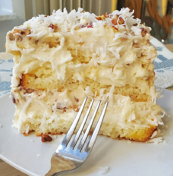 this is a light made from scratch Italian cream cake with coconut and pecans in a cream cheese frosting