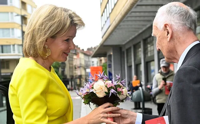 Queen Mathilde wore a lemon yellow top by Natan, and white trousers by Natan Couture. Queen Elisabeth International Music Competition