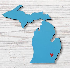 blue magnet shaped like the state of Michigan, with a heart where Ann Arbor would be