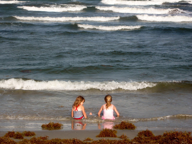 Little Girlfriends sitting on the beach 