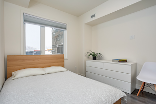 a photo of a room with bed and dresser that are real with books and plant added digitally.