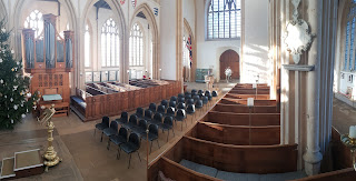 A church where a third of the pews have been replaced with chairs