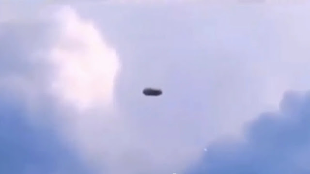 Black UFO sighting hiding in the cloud's recorded by witness.