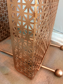 Give a Mid-Century Modern magazine rack new life with a coat of metallic spray paint!