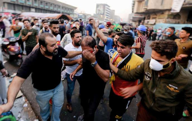 A protester, A protester injured, Iraqi police, Baghdad, Iraqi police in Baghdad