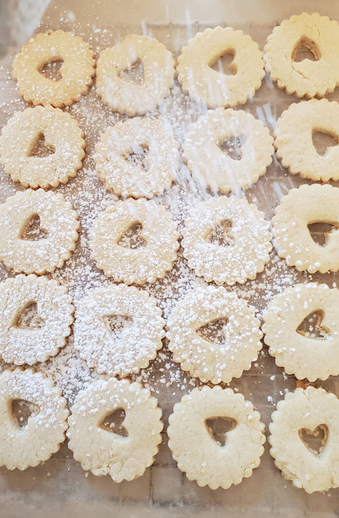 plate of valentine heart linzer cookies dusted with sugar
