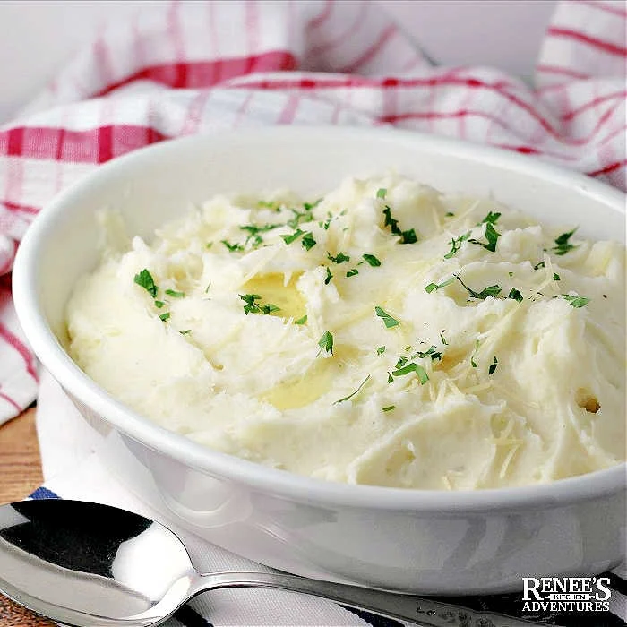 Garlic Parmesan Mashed Potatoes in a white serving bowl