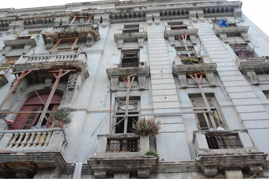 Old building in Havana with balcony supports