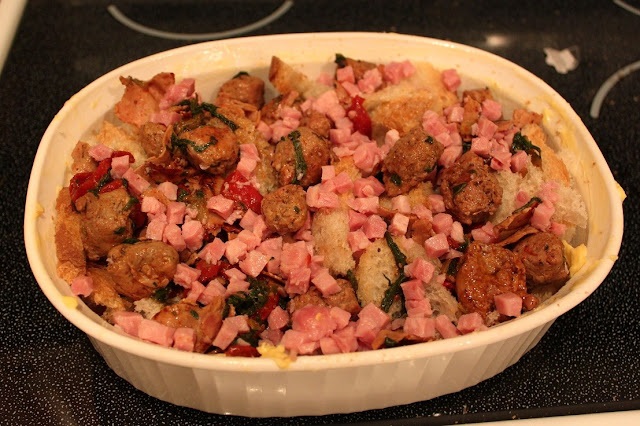 meats in the casserole dish and cubed bread for breakfast meal