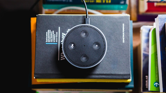 black Amazon Echo on black covered book(internet of things)