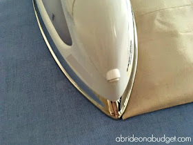 If your dress pants are a little long, you'll want to hem them. Find out how to blind hem your dress pants for a wedding in this post from www.abrideonabudget.com.