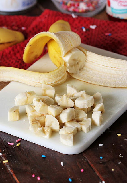 Quartered Banana Slices on Cutting Board Image