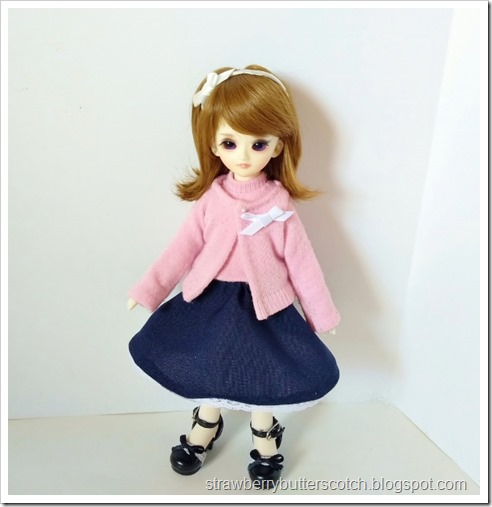 The cute doll outfit worn by a ball jointed doll.