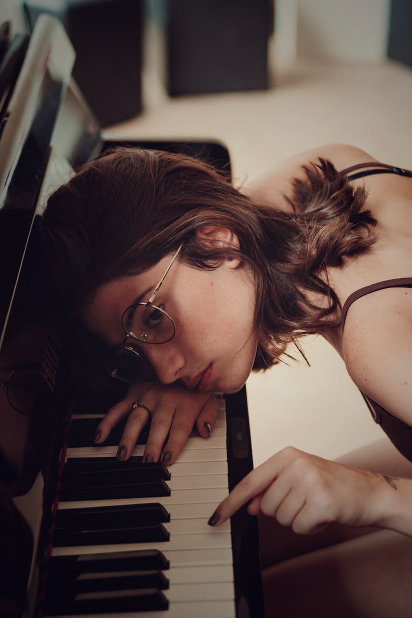 Woman leaning on piano