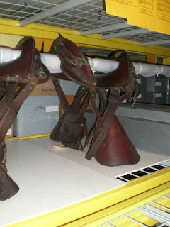 Museum storage of leather artifacts, historic saddles, McClellan, civil war cavalry