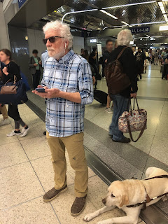 Paul pausing briefly to check his progress on the Loud Step indoor navigation app at Chicago's O'Hare airport