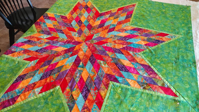 Scrappy Lonestar quilt using Empress Garden fabrics by Island Batik