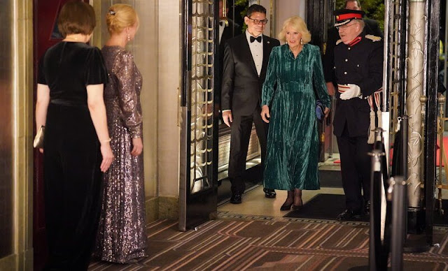 Queen Camilla wore a green crushed velvet elegant maxi dress by Me+Em. Van Cleef and Arpels Alhambra diamond earrings