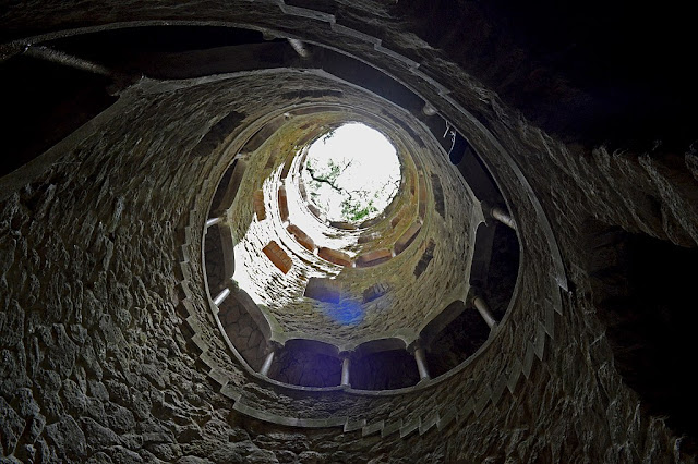 Looking up at the sun from inside of a well