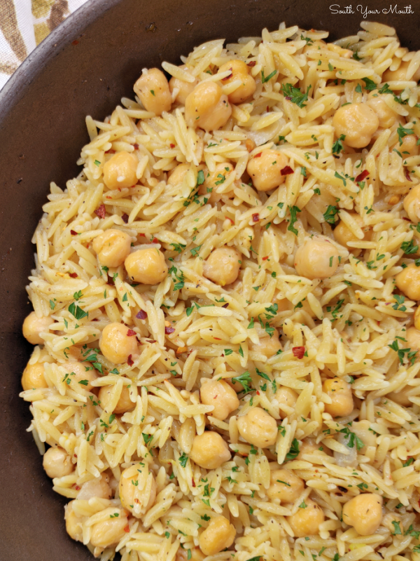 Spicy Chickpeas with Orzo! A Mediterranean inspired recipe with chickpeas (garbanzo beans), orzo and layers of spices and mild heat that doubles as the perfect side or a meatless main dish.