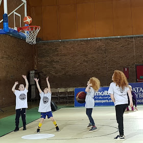 Manchester giants child scoring a basket while 3 more watch 