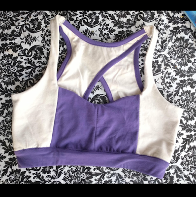 sports bra/bralette in cream and purple on a black and white table cloth