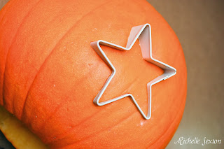 star cookie cutter pressed into pumpkin