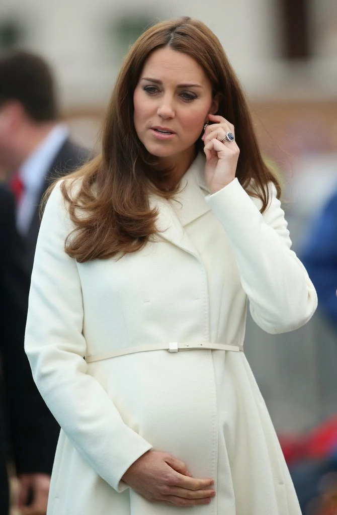 Kate Middleton flaunts baby bump in a white coat and printed dress at the Ben Ainslie Racing in Portsmouth