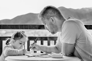 man drawing with daughter