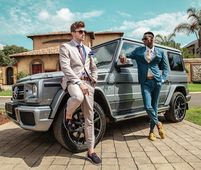 Rich men standing by an expensive car