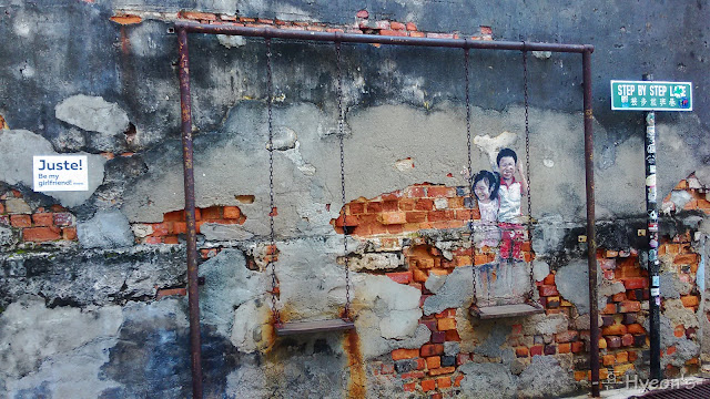 children on swing street art penang