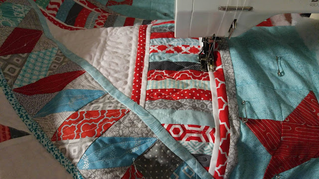 Red and aqua string star round robin quilt