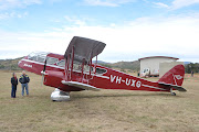 It is believed the plane is vintage red de Havilland Dragon DH84 VHUXG, . (old station )