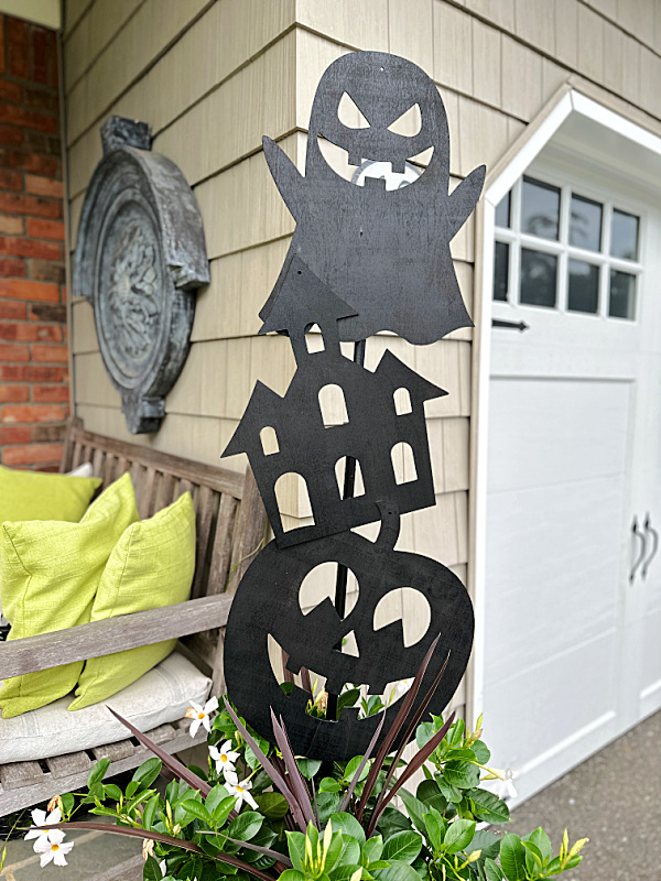 vertical halloween decoration in a planter