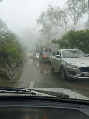 "Tourists heading up the hill for the weekend, on a misty day."