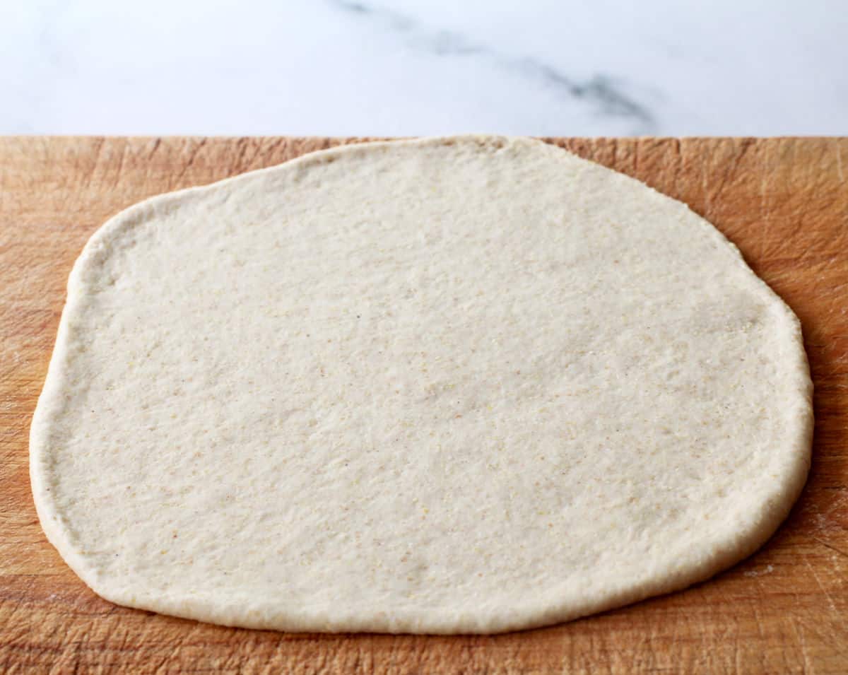 Sourdough Lebanese Morning Bread (Khobz al-Sabah) rolled out on a bread board.