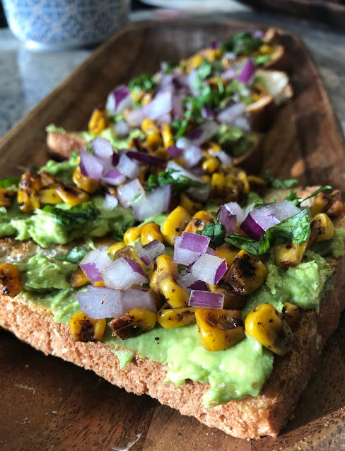 Roasted corn avocado toast on platter