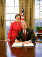 President George W. Bush is joined by Mrs. Laura Bush in the Oval Office at the White House, Thursday, Feb. 1, 2007, as President Bush prepares to sign the Presidential Proclamation in honor of American Heart Month. American Heart Month encourages Americans to take actions that reduce their risk and increase awareness of heart disease. White House photo by Eric Draper.