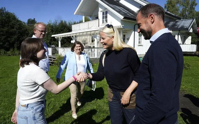 Crown Princess Mette-Marit wore a navy blue cashmere sweater. Fjallraven black and beige trekking trousers