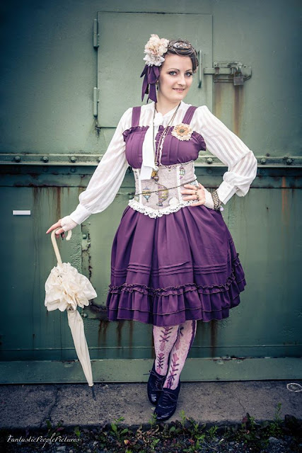 Colorful Steampunk Lolita purple dress, corset, blouse, fascinator and parasol.