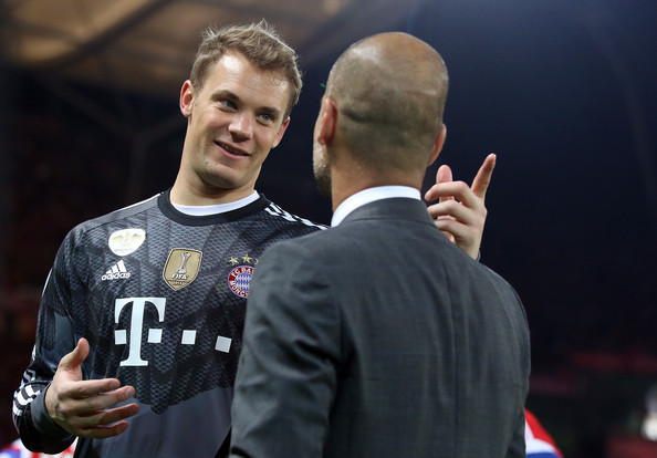 Goalkeeper Manuel Neuer and head coach Josep Guardiola of Bayern Munich chat after winning the DFB Cup Final match 2014 between Borussia Dortmund and Bayern Munich at Olympiastadion on May 17, 2014 in Berlin, Germany