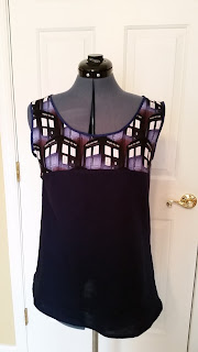 Direct view of sleeveless shirt with Tardis on top and dark blue on the bottom.