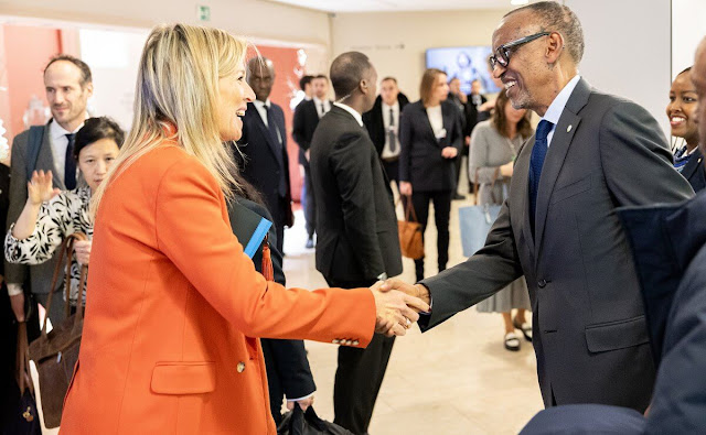 Queen Maxima wore an orange wool stretch blazer suit by Joseph, and orange coral sweater. Joseph wide leg trousers