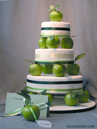 A three tier round wedding cake with beautiful big green apple separating 